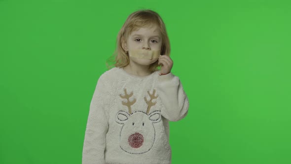 Positive Girl in Sweater with a Deer. Glued Mouth with Adhesive Tape. Chroma Key