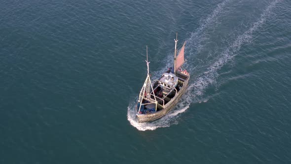 Fishing Boat in the Early Morning Heading Out to Sea