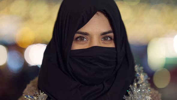 Closeup Positive Middle Eastern Woman in Headscarf Covering Face Looking at Camera with Hazel Eyes