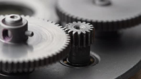 Gears rotating in a mechanical device. Machine metal gears rotating abstract