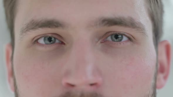 Close Up of Blinking Eyes of Young Businessman
