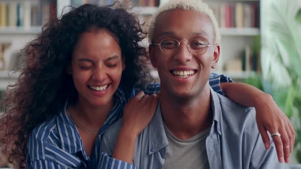 Smiling Biracial Couple Rest on Cozy Sofa Have Fun Enjoying Leisure Weekend