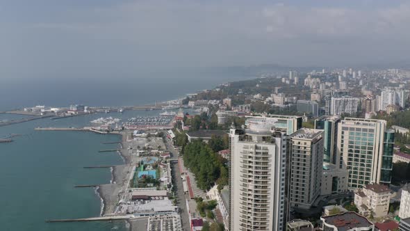 Aerial Panning View Rotation Shot Sochi Cityscape with District Street Infrastructure and Coast