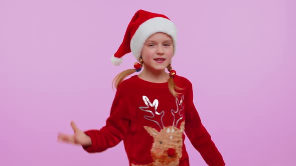 Girl in Christmas Santa Sweater Hat Dancing Trendy Dance for Social Media Fooling Around Having Fun