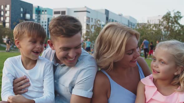 A Beautiful Family Laughs and Smiles in the Street