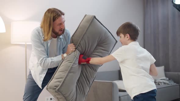 Entertainment at Selfisolation Father and Son Play Boxing a Boy in Red Gloves on His Hands Beats a