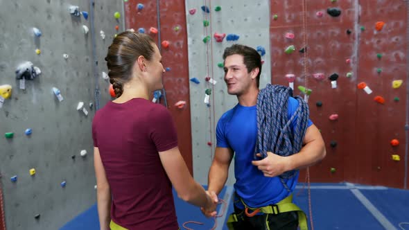 Man and woman interacting with each other during bouldering 4k