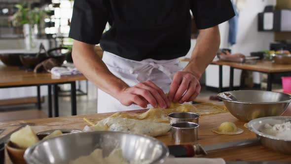 Diverse group of chefs preparing dishes and smiling in a kitchen