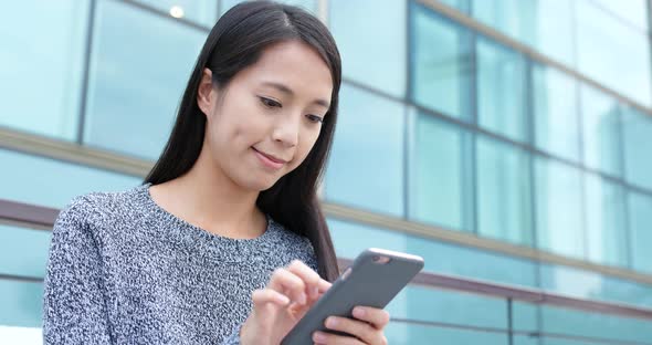 Woman use of smart phone in city