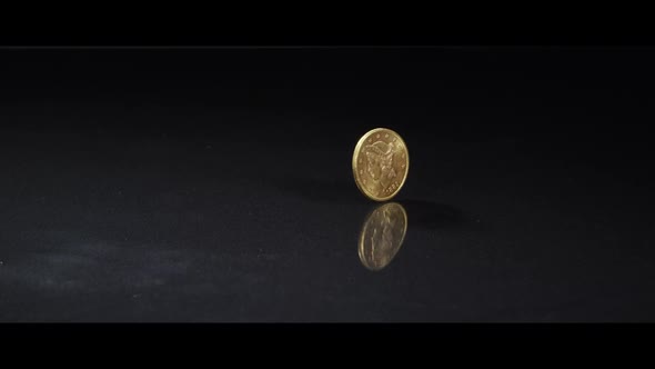 Spinning coin on a reflective surface - MONEY 0048