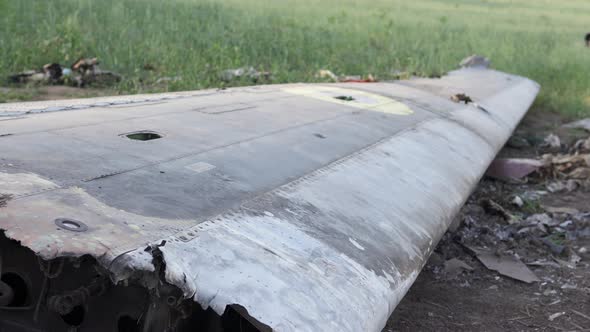 Downed military transport aircraft in a wheat field. Russian aggression in Ukraine.