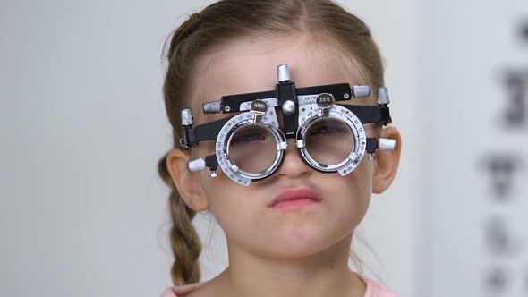 Sad Schoolgirl in Optical Trial Frame, Eyesight Testing, Eyeglasses Prescription