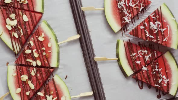 Watermelon drizzled with chocolate and topped with flaked sea salt, almonds and coconuts.