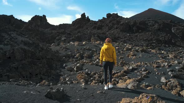 Woman Traveler Walks Through the Lava Field Around Chinyero Volcano in the Teide National Park on