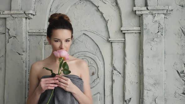 Sexy Girl in Towel with Flower Is a Rose in the Bathroom