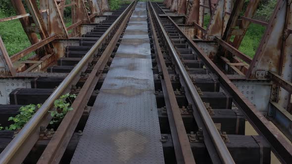 Rusty single railway track and bridge 4K aerial video
