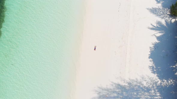 Aerial: Woman on White Sand Beach Turquoise Water Tropical Coastline Caribbean Sea