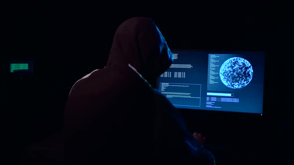 Hacker Enters the Virus Data Into the Computer