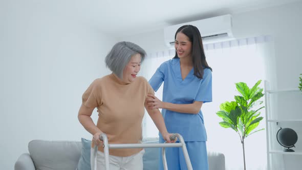 Asian senior older woman patient doing physical therapy with caregiver.