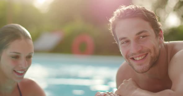 Woman and Man Smiling Near Swimming Pool Water