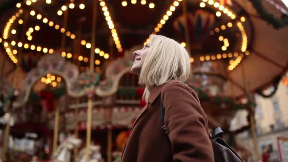 Woman near Christmas carousel