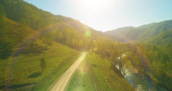 Low Altitude Flight Over Fresh Fast Mountain River with Rocks at Sunny Summer Morning.