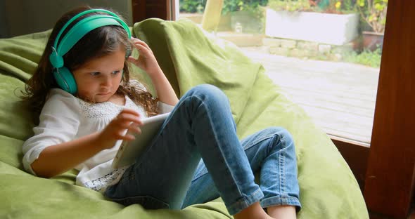 Girl using digital tablet at home 4k