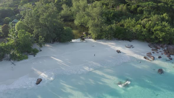 Aerial view of a person walking on the beach of Anse Lazio, Seychelles.