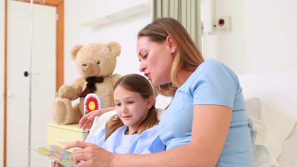 Mother with her daughter sitting on a hospital Bed