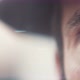 Close up of a man's blue eyes while light flares move around. - VideoHive Item for Sale