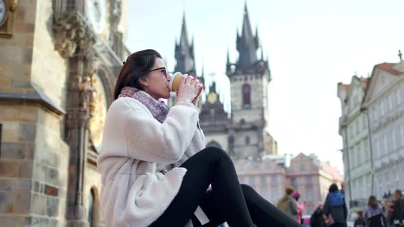 Pretty European Tourist Woman Relaxing Drink Coffee at Historic Square with Amazing Architecture