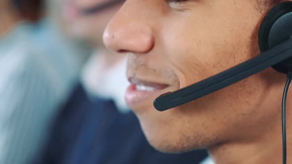 Extreme Close-up Shot of Mixed-race Man in Headset Talking To Somebody in Office