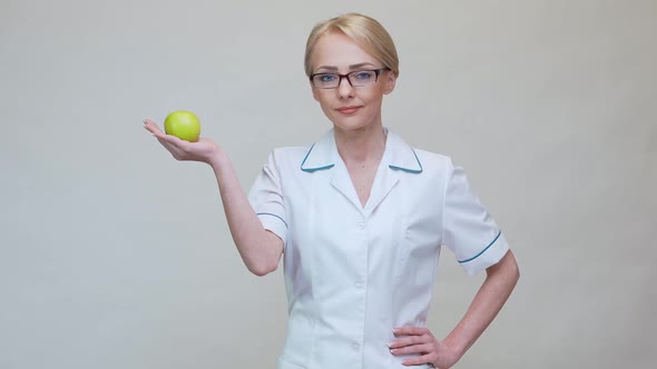 Nutritionist Doctor Healthy Lifestyle Concept - Holding Organic Green Apple
