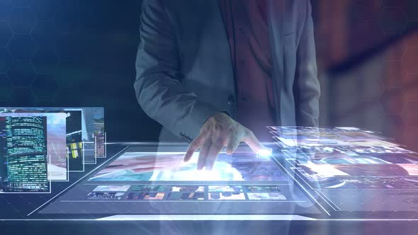 A Man Views Photos and Videos on a Virtual Reality Panel.