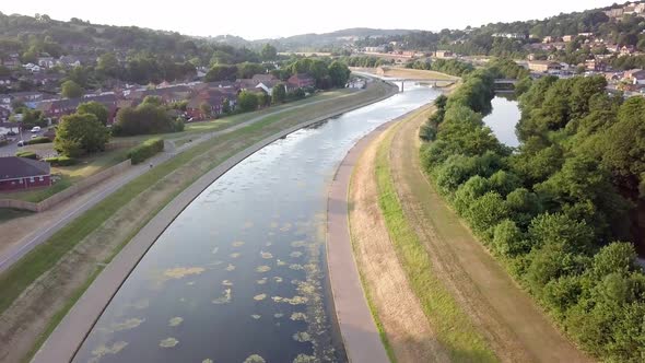 Aerial fly over of beautiful River Exe at golden hour in Exeter, Devon, UK