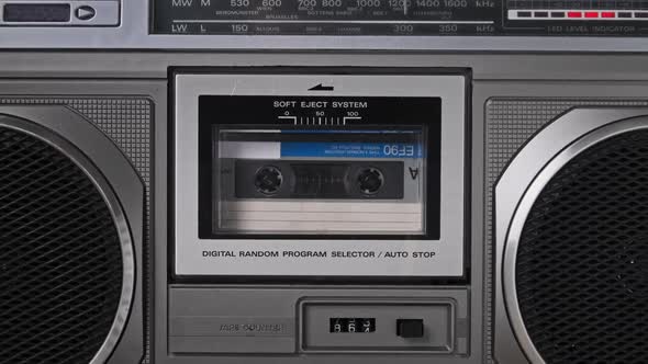 Audiocassette Rotates in Deck of an Old Tape Recorder