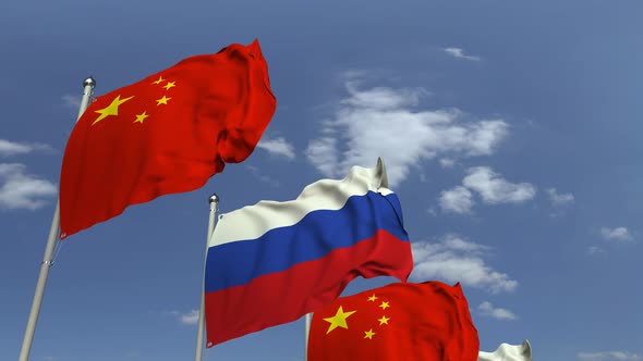 Flags of Russia and China Against Blue Sky