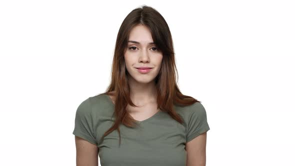 Portrait of Gorgeous Woman with Long Aubur Hair Wearing Basic Tshirt Posing at Camera with Kind