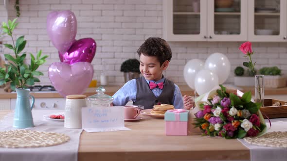 Little Cute Son Serving Breakfast Table for Mother