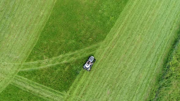 Riding lawn mower in action seen from the sky