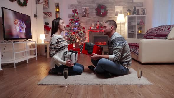 Zoom in Shot of Couple Exchanging Gifts