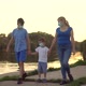 A Family with a Child in Medical Masks Walk Near the Lake - VideoHive Item for Sale
