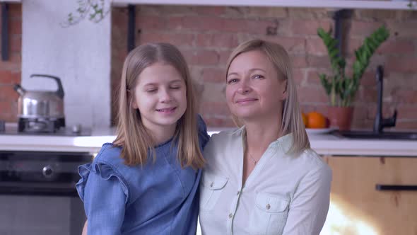 Maternal Tenderness, Portrait of Smiling Mother with Lovely Child Girl Kiss Each Other and Look at