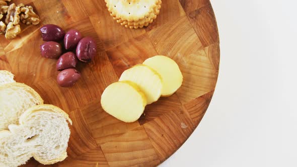 Slices of cheese with bread, olives and crispy biscuits