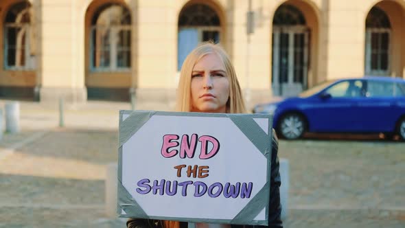 Concerned Woman with Protest Banner Calling to End Shutdown