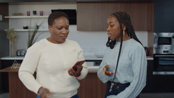 Busy with Phone Mom Phubbing Teenage Daughter at Home