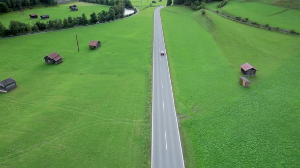 Road in Austria Between Green Fields In an Alpine Village Aerial View