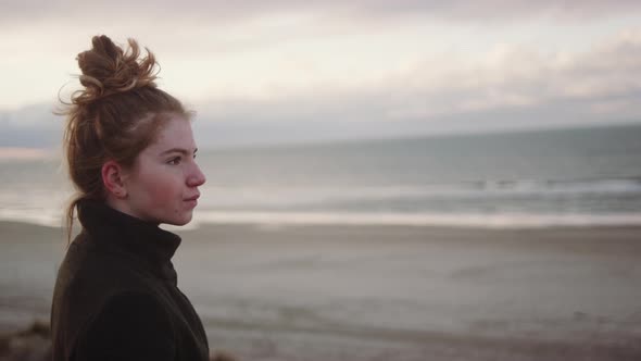 Teenage Girl With Red Hair Tied Up At Beach