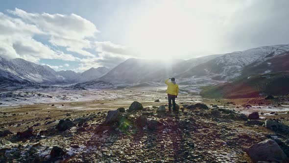 Young Hiker Reaching The Top Outstretched Arms Success Pose At Sunset In Snowy Mountain Range Aerial