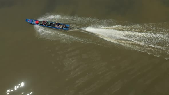 Top down shot of a blue speedboat on the Kenh Te Canal. This waterway connects The Mekong Delta to